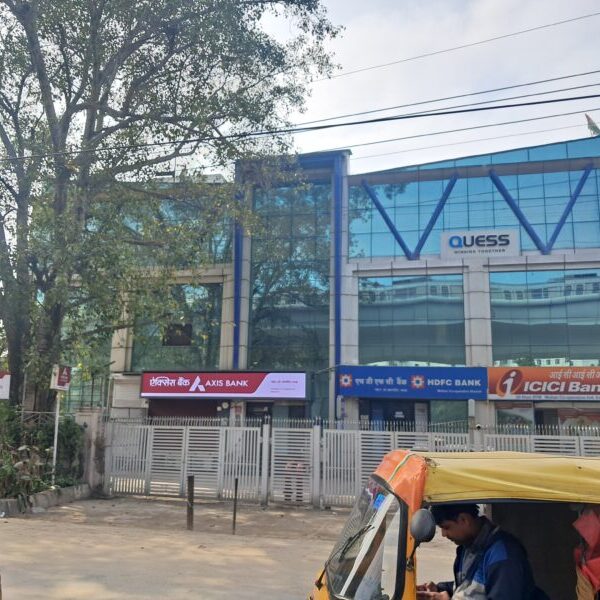 Modern commercial office building lift lobby and fire safety equipment in Okhla.