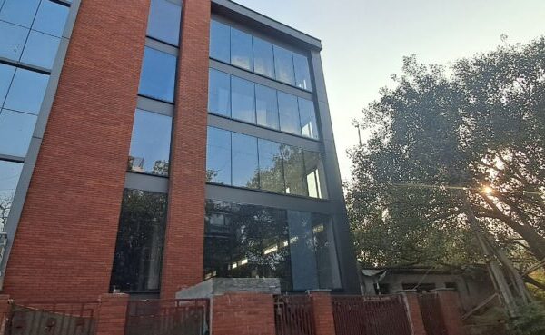 Modern commercial building exterior with easy metro transit access in Okhla Phase 3.