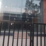 Modern commercial building facade with secure gated entry, lift access, and dedicated parking in Okhla Phase 2.