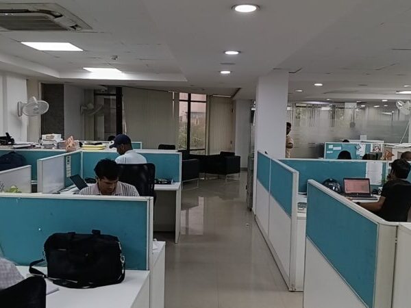 Modern commercial property exterior facade with wide entry and parking in Okhla Phase 3 Delhi.