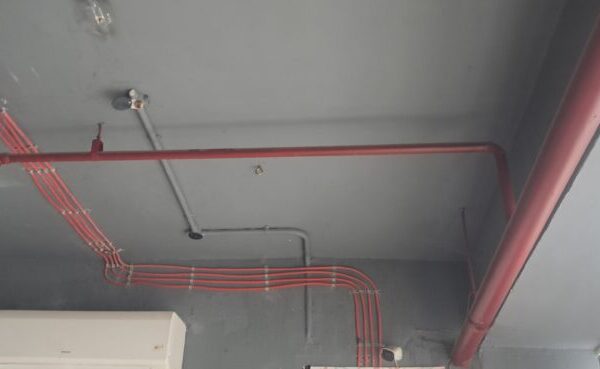 Heavy-duty electrical power distribution panel and safety equipment in Okhla Phase 2 DDA shed.