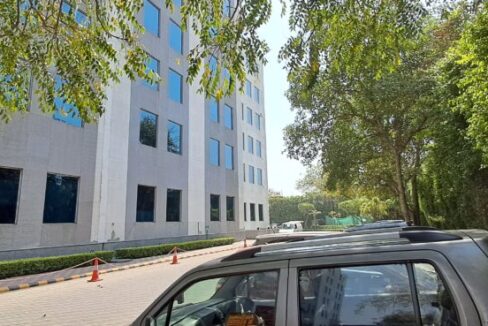 Modern glass and steel exterior facade of DLF Prime Towers commercial building in Okhla Phase 1.