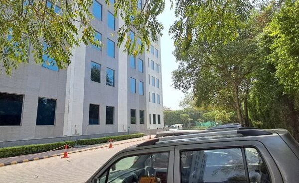 Modern glass and steel exterior facade of DLF Prime Towers commercial building in Okhla Phase 1.