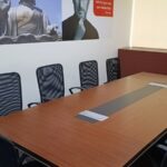 Large conference boardroom table with executive seating in a fully furnished office lease property in Okhla.