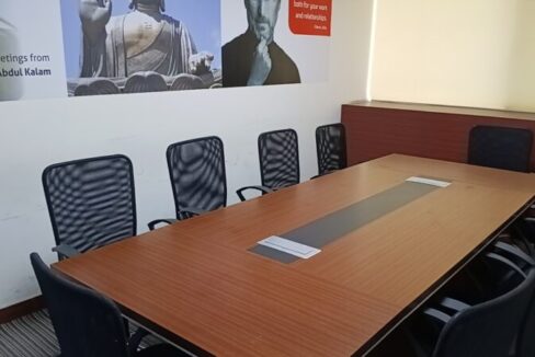Large conference boardroom table with executive seating in a fully furnished office lease property in Okhla.