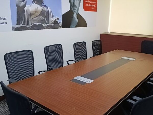 Large conference boardroom table with executive seating in a fully furnished office lease property in Okhla.