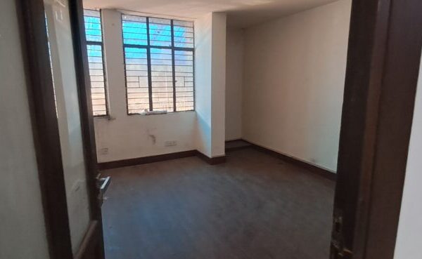Private glass-walled mini cabin for founders inside a small office rental in Okhla Phase 3.