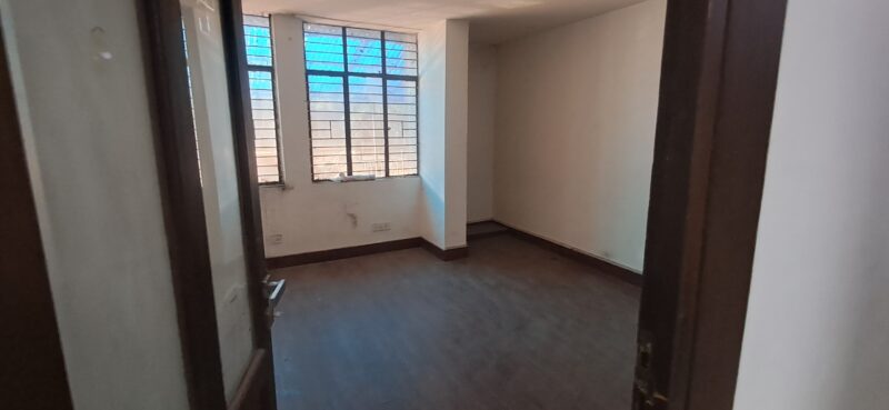 Private glass-walled mini cabin for founders inside a small office rental in Okhla Phase 3.