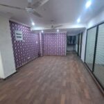 Premium corporate reception desk and waiting lounge inside a furnished office space for lease in Okhla.
