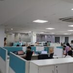 Rows of pre-installed ergonomic workstations and chairs in a furnished commercial office lease in Okhla.