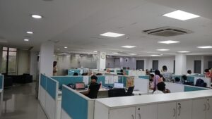 Rows of pre-installed ergonomic workstations and chairs in a furnished commercial office lease in Okhla.