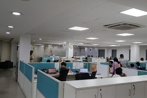 Rows of pre-installed ergonomic workstations and chairs in a furnished commercial office lease in Okhla.