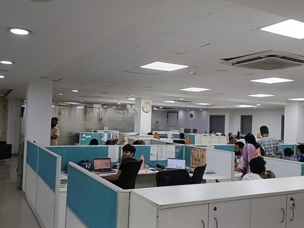 Rows of pre-installed ergonomic workstations and chairs in a furnished commercial office lease in Okhla.