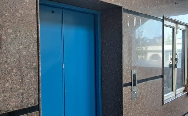 Clean and spacious elevator lobby with high-speed commercial lifts in an office building in Okhla Phase 3 Delhi.