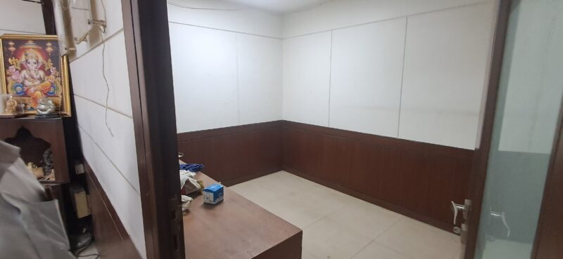 Clean, compact wet pantry setup with storage cabinets in a small rental office in Okhla Phase 3.