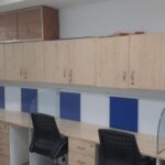 Rows of ergonomic open workstations with structured cable management in an Okhla Phase 2 rental office.