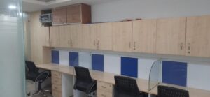Rows of ergonomic open workstations with structured cable management in an Okhla Phase 2 rental office.